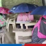 বৃষ্টির পানিতে ছাতা মাথায় পরীক্ষা দিলেন শিক্ষার্থীরা